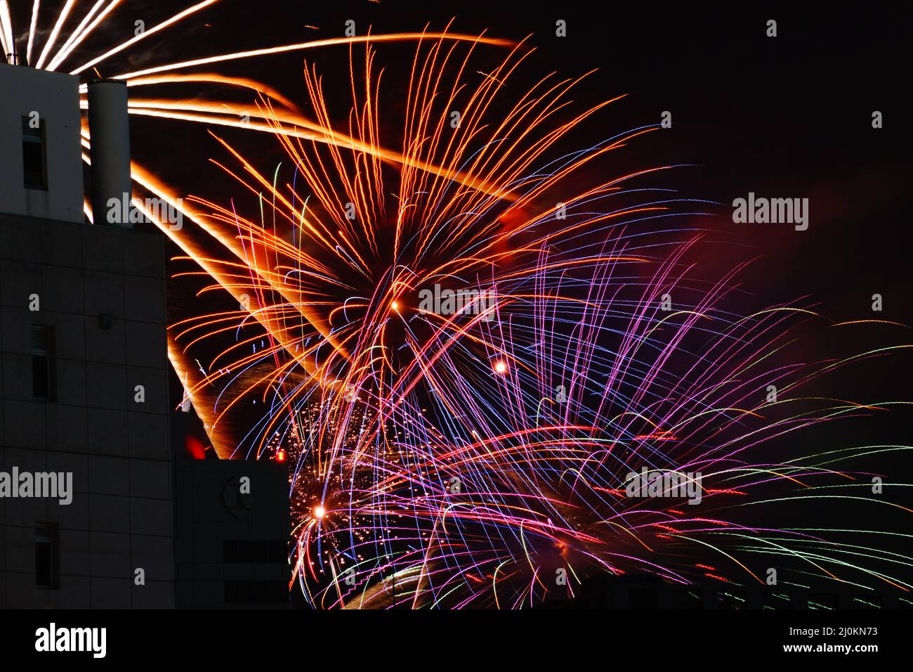Fireworks visible from Between building Stock Photo Alamy