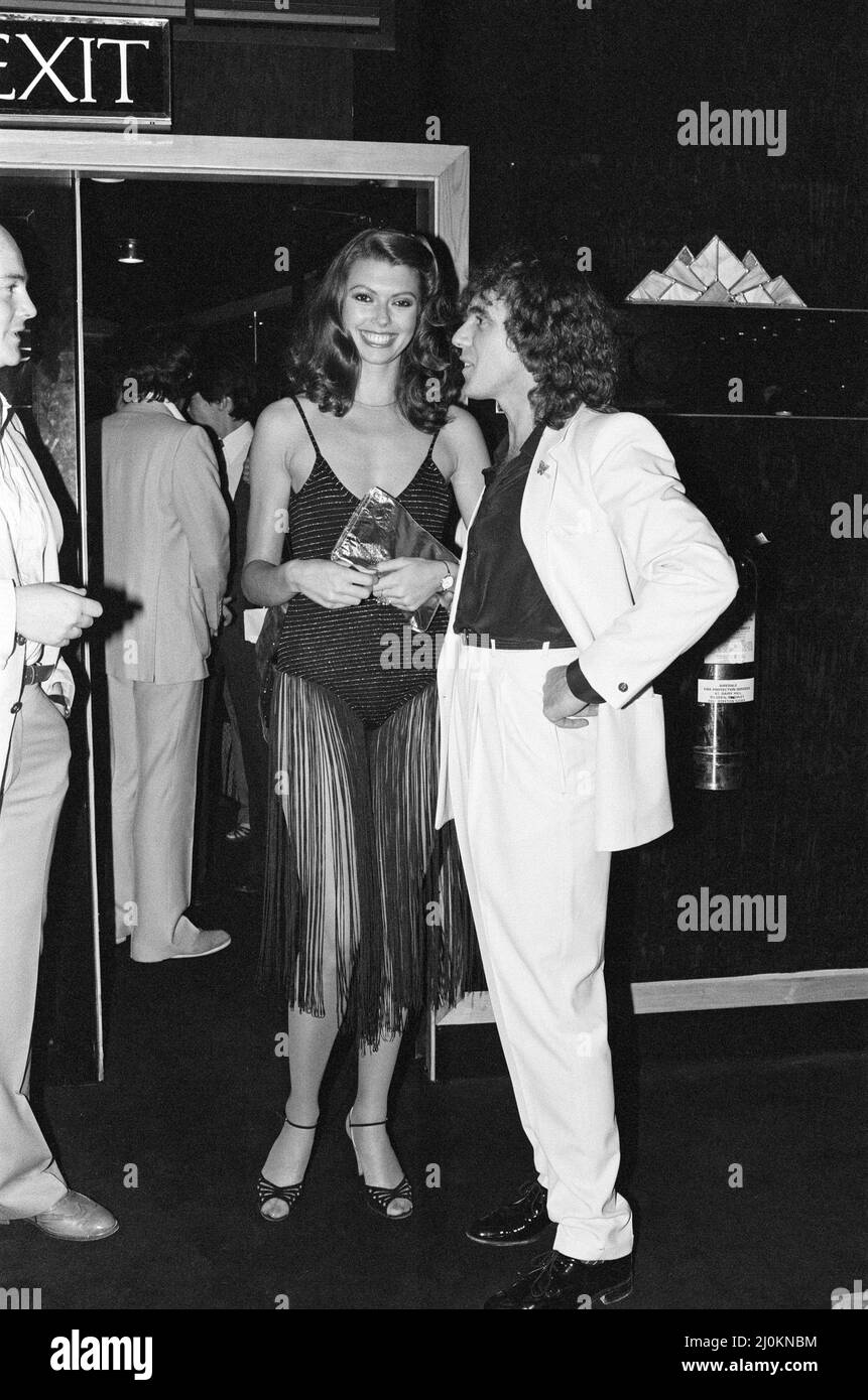 Peter Stringfellow, owner of the new nightclub Stringfellows in Covent Garden, pictured at the nightclub with a guest. London. 1st August 1980. Stock Photo