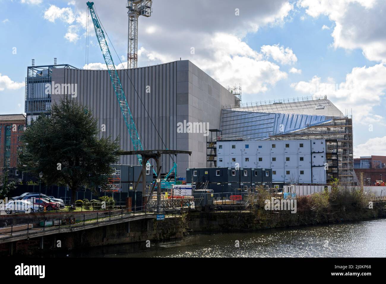 The Factory International arts building under construction March 2022, over the river Irwell.  St. John's, Manchester, England, UK Stock Photo