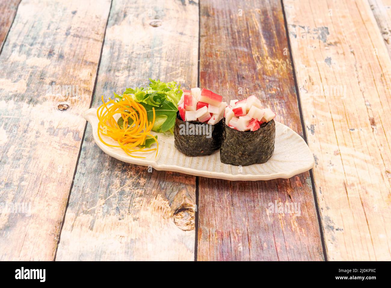 Surimi taco sushi gunkan tacos with japanese rice and salad on white