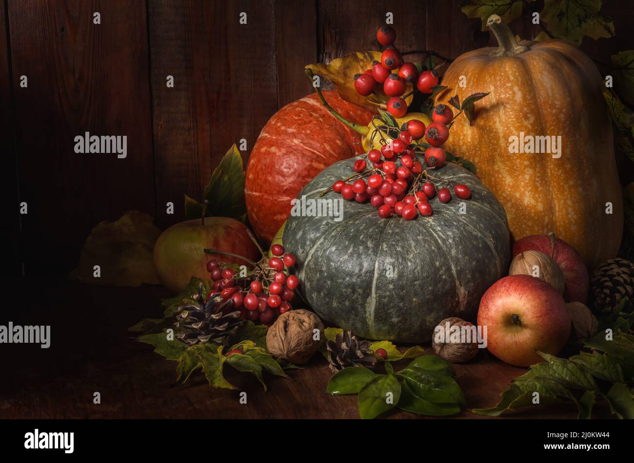 Pumpkin and other fruits on a dark wooden background in a rustic style Stock Photo