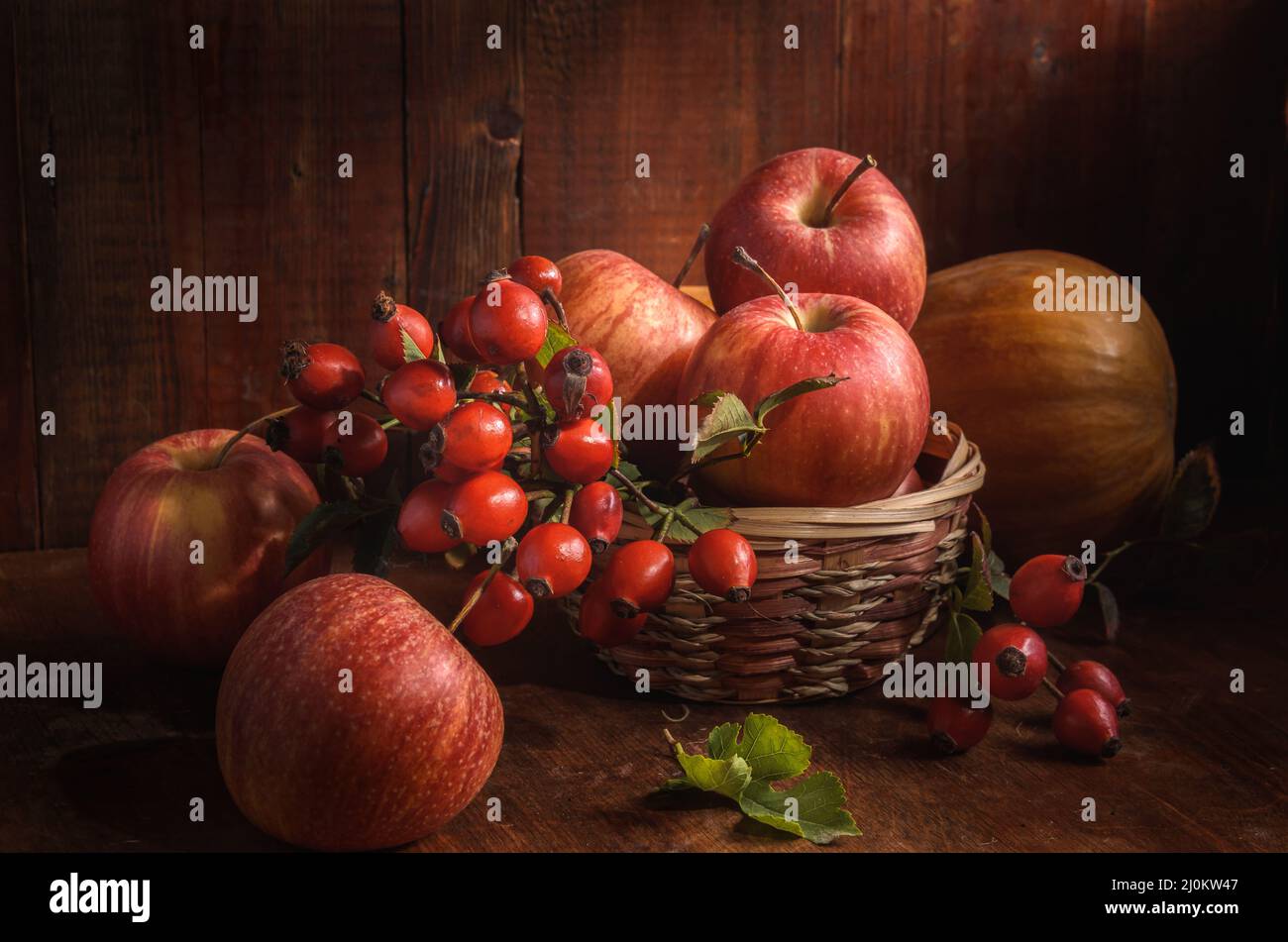 Apples and other fruits on a dark wooden background in a rustic style Stock Photo