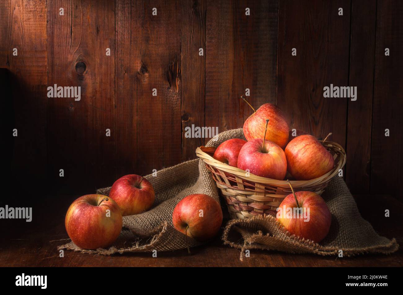 Apples on a dark wooden background in a rustic style Stock Photo - Alamy