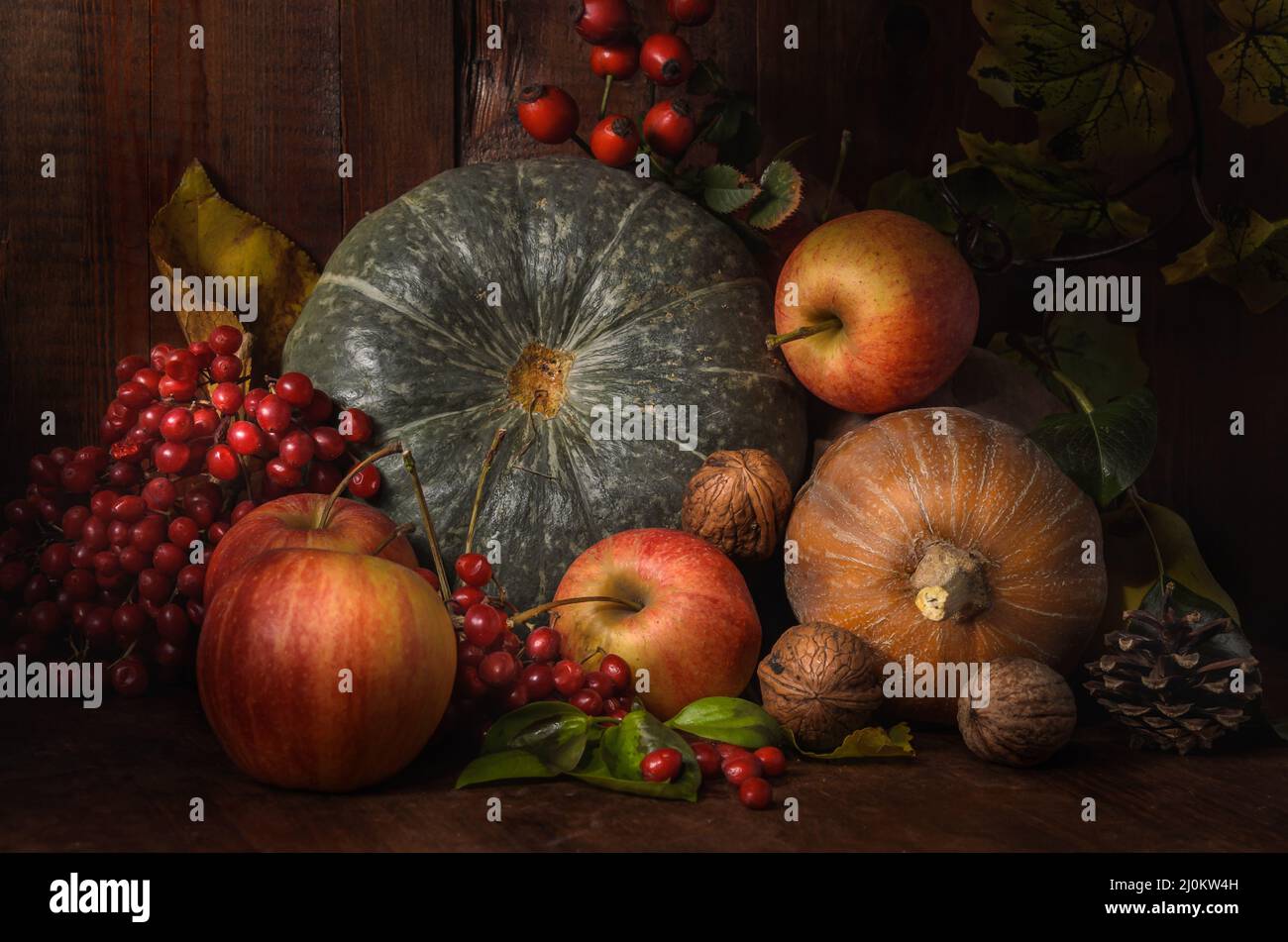 Apples and pumpkin on a dark wooden background in a rustic style Stock Photo