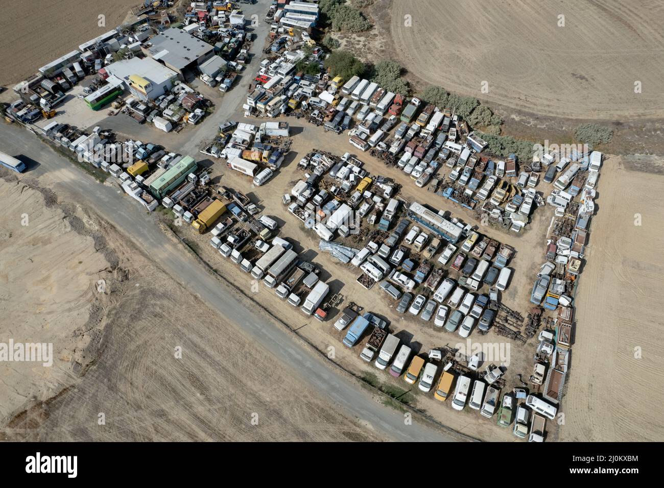 Aerial drone top view of smashed destroyed car wrecks on car junkyard. Stock Photo