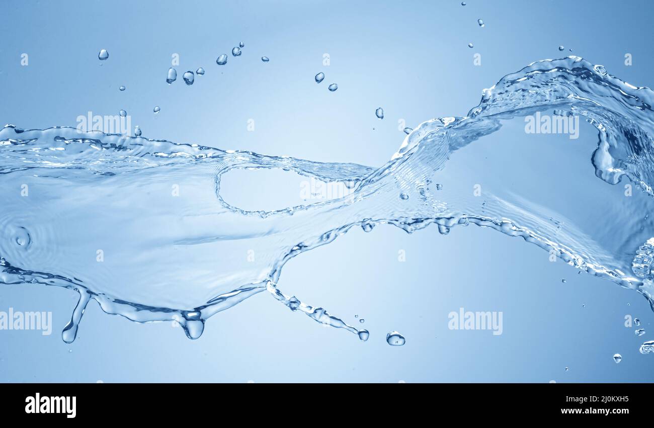 Water splash isolated on blue background Stock Photo - Alamy