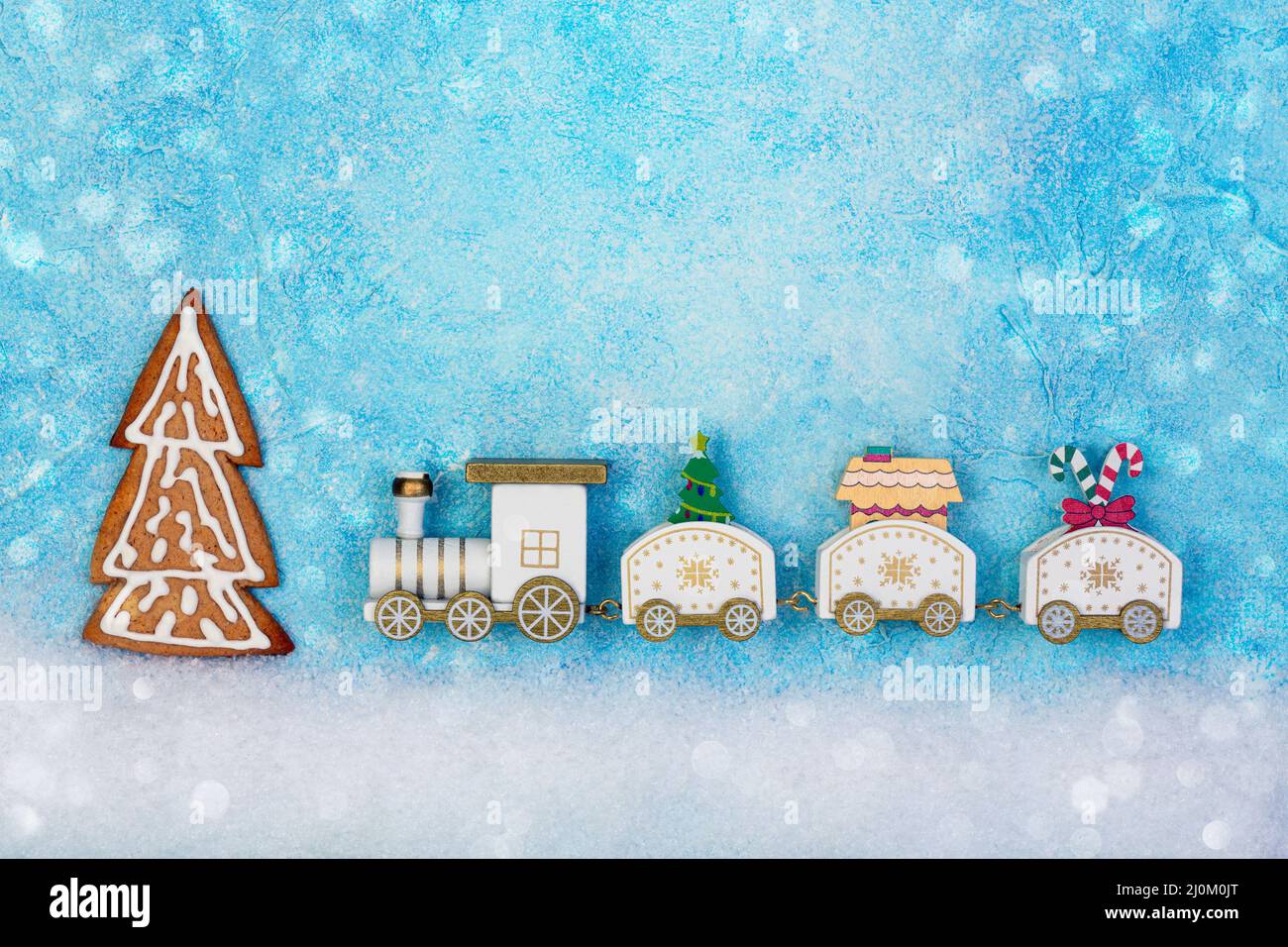 Christmas toy train with a Christmas tree and gifts. Stock Photo