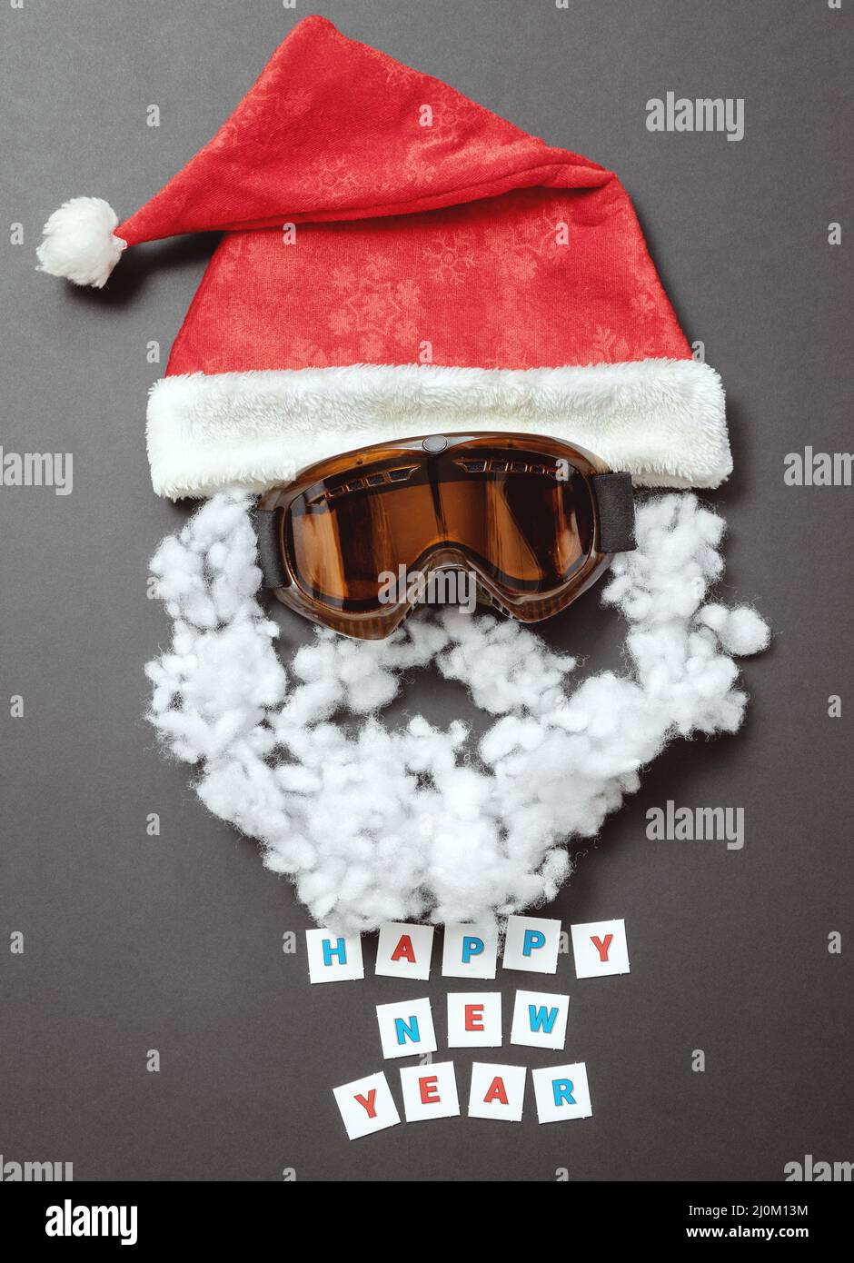 Red velvet hat with snow mask and cotton mustache and beard. Cheerful New Year card Stock Photo
