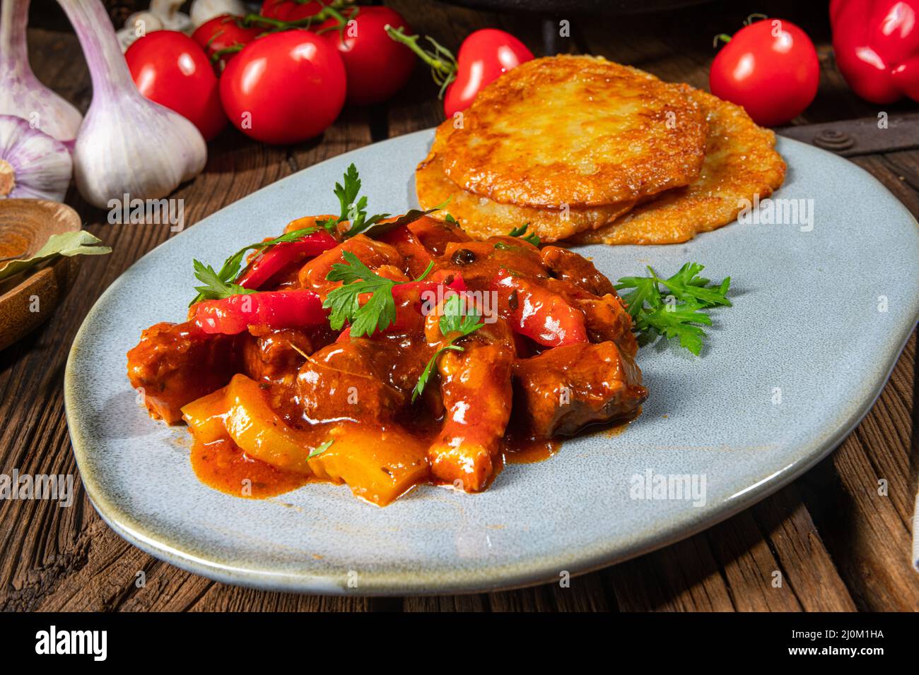 Original Hungarian goulash with potato pancakes Stock Photo Alamy