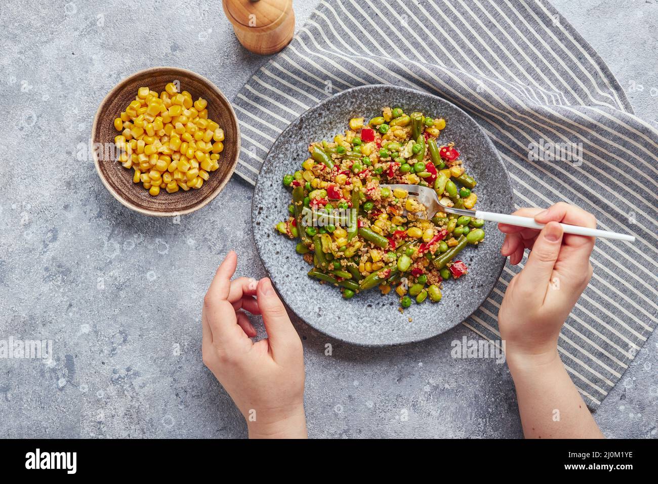 Quinoa salad with green beans, corn, red bell peppers, peas and