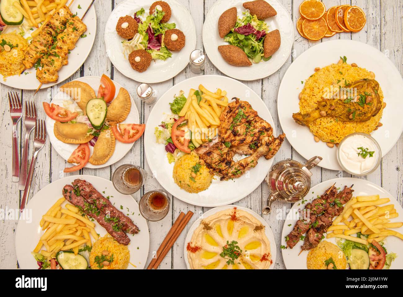 Persian food dishes with charcoal grilled chicken, patties, grilled