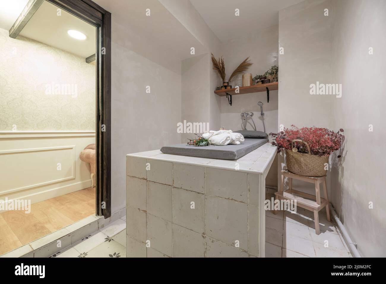 Hamman sauna with tile table and hot stones to release steam, shelves