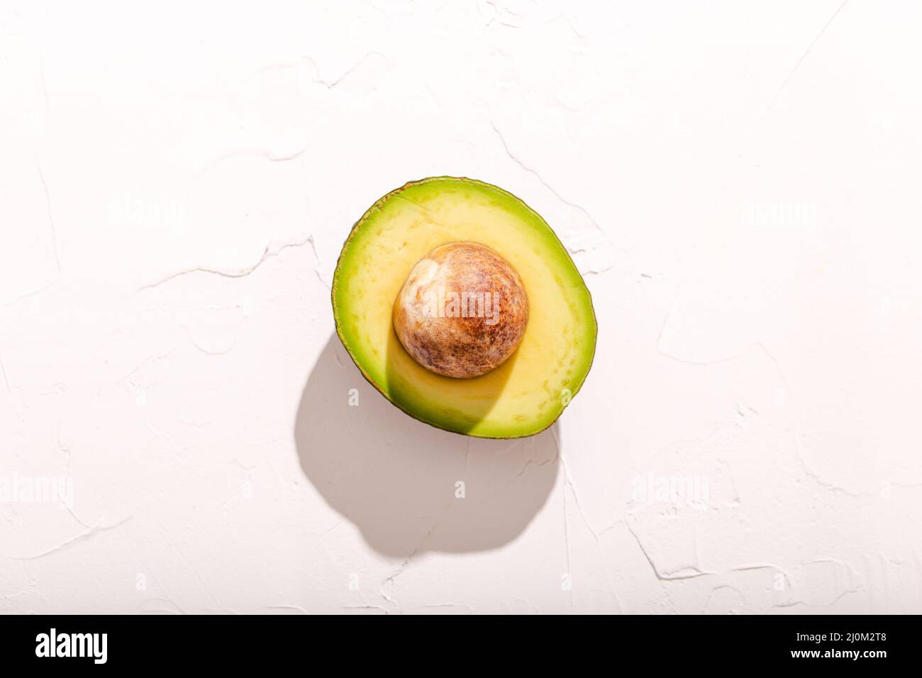 Half cut avocado on white background Stock Photo