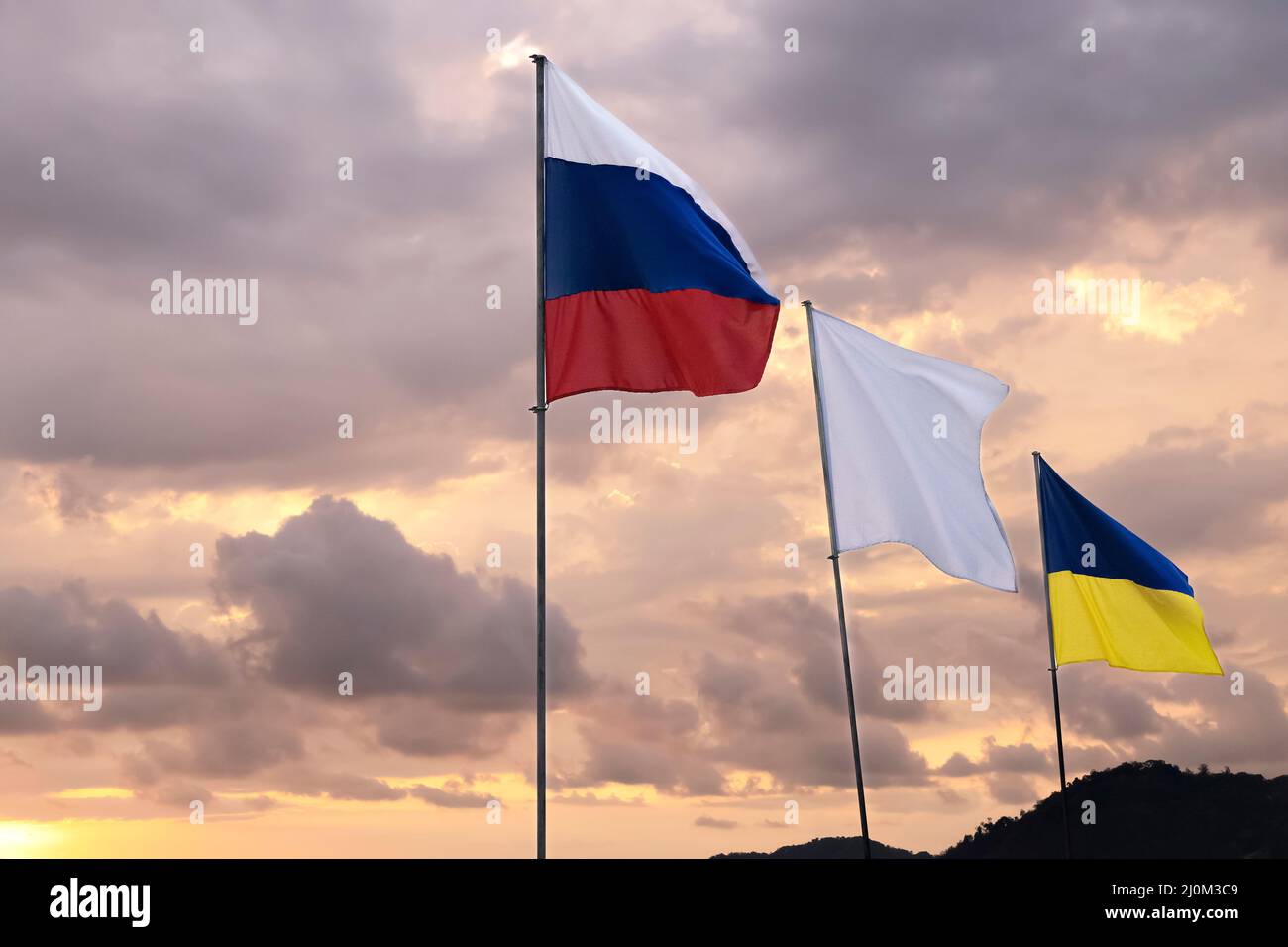 Ukrainian and Russian flags on dramatic sky background. Stock Photo