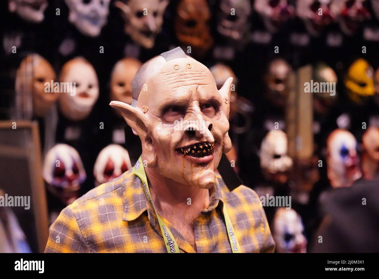 St. Louis, United States. 19th Mar, 2022. A sales person shows off a mask to prospective customers during the Transworld Halloween & Attractions Show at America's Center in St. Louis on Saturday, March 19, 2022. The trade show that serves the Haunted House and Halloween industry, attracts thousands from across the country with everything Halloween related. Photo by Bill Greenblatt/UPI Credit: UPI/Alamy Live News Stock Photo