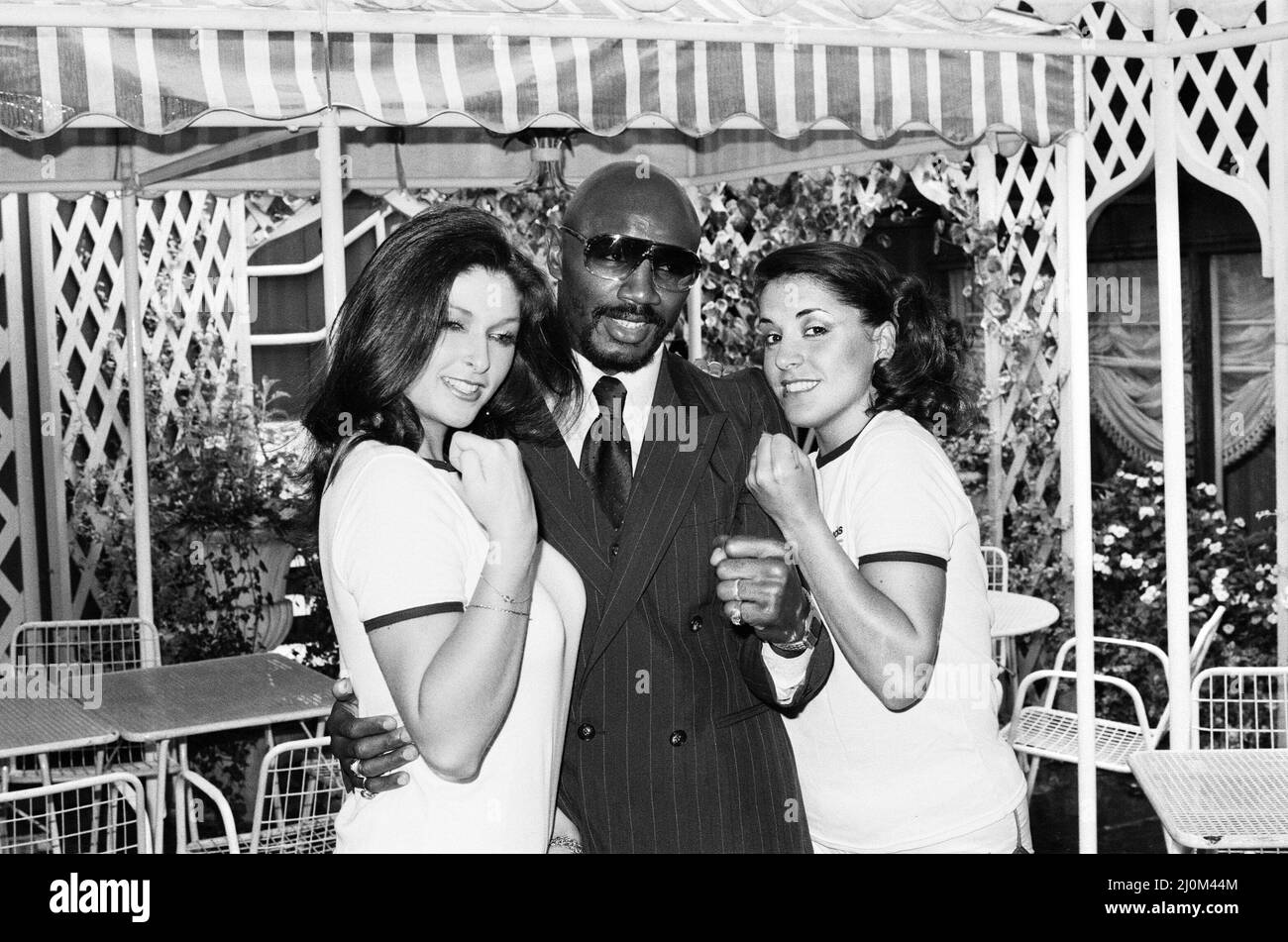 Marvin Hagler in London to challenge WBC, WBA champion Alan Minter. Hagler won by TKO in the third round. Hagler went six years undefeated before losing his titles to Sugar Ray Leonard in 1987.(Picture) Hagler posing with models. 18th September 1980 Stock Photo