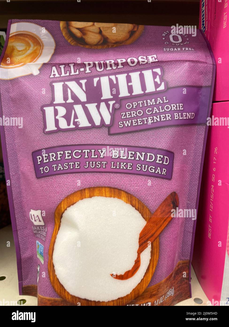 Grovetown, Ga USA - 03 13 22: Artificial sweeteners on retail store shelf Pink bag Sugar in the raw Stock Photo