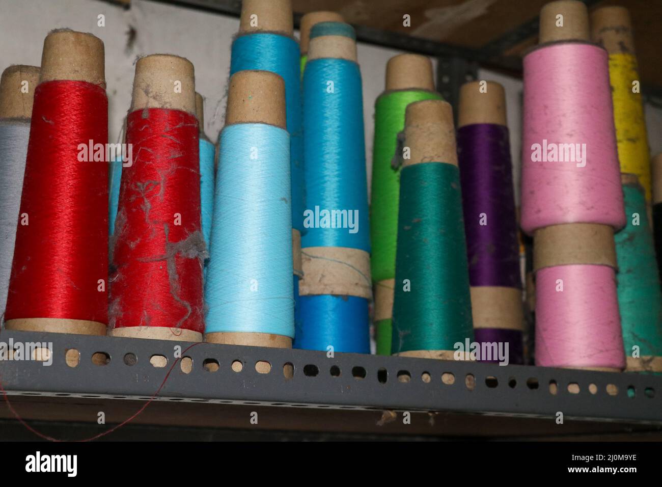 Set of colored threads for sewing on coils. Pile of big colorful spools of  thread. Colored thread spools of thread large class, textiles, background  Stock Photo - Alamy