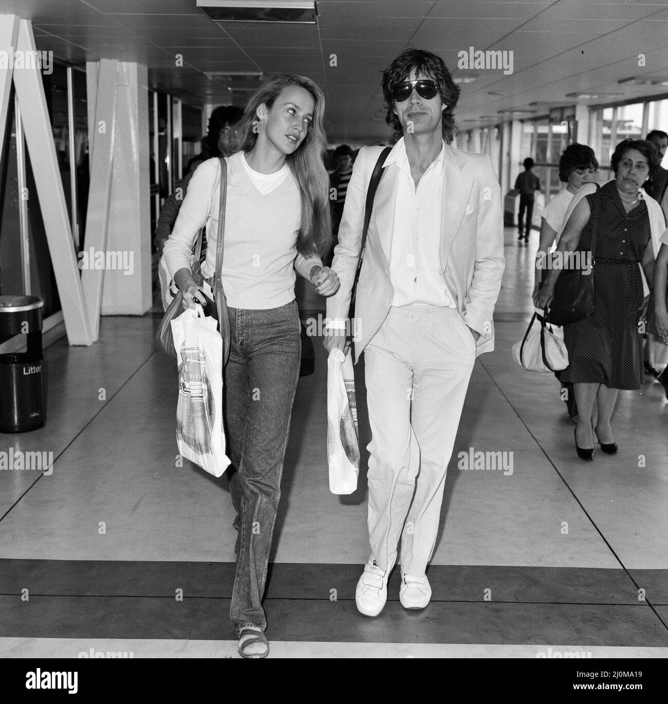 Mick Jagger and girlfriend, model, Jerry Hall, pictured at London Heathrow Airport, departing for India, 28th July 1981. Stock Photo