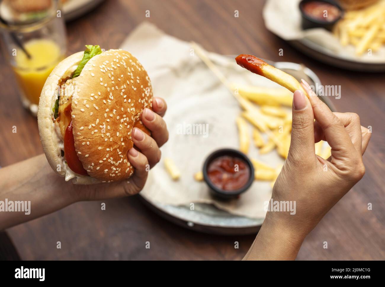 High angle person eating burger french fries Stock Photo