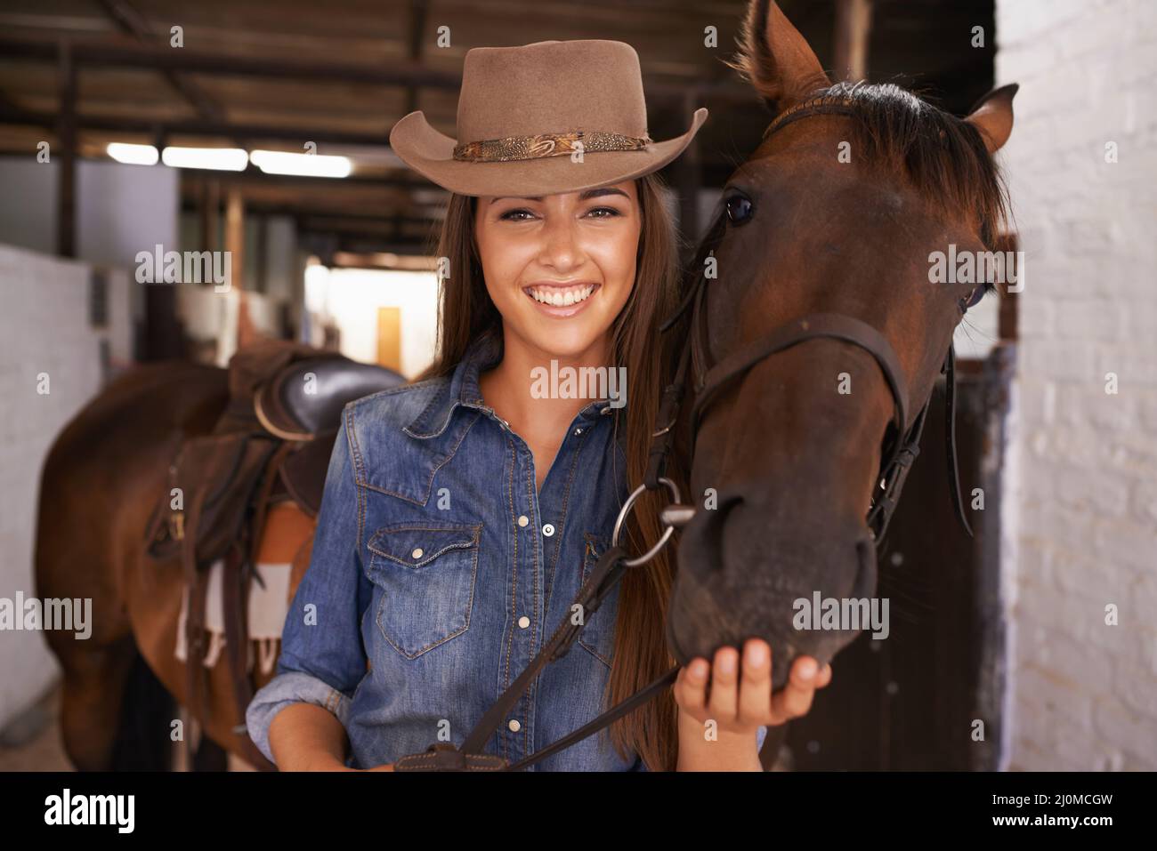 A girls best friend. Shot of a young woman tending to her horse. Stock Photo