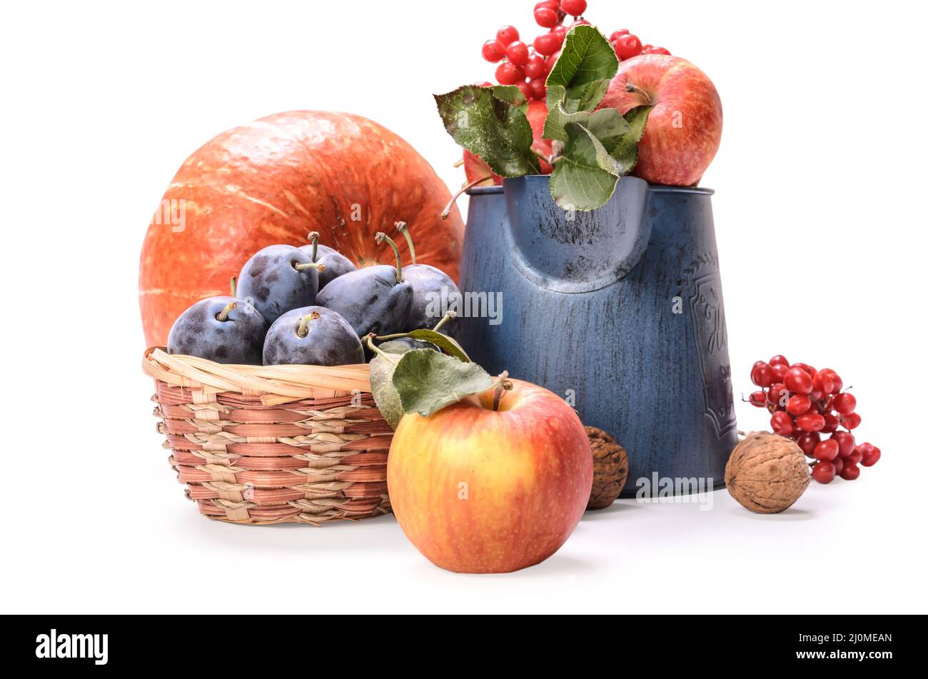 Apples in a garden jug and other fruits on a white background with soft shadow Stock Photo