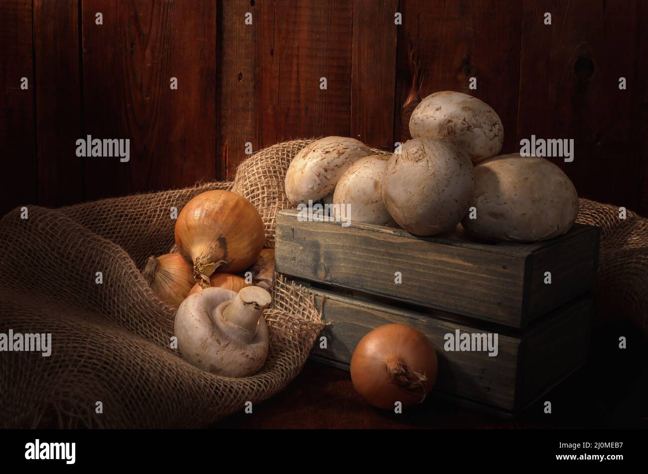 Mushrooms in a wooden box on a dark wooden background in a rustic style Stock Photo