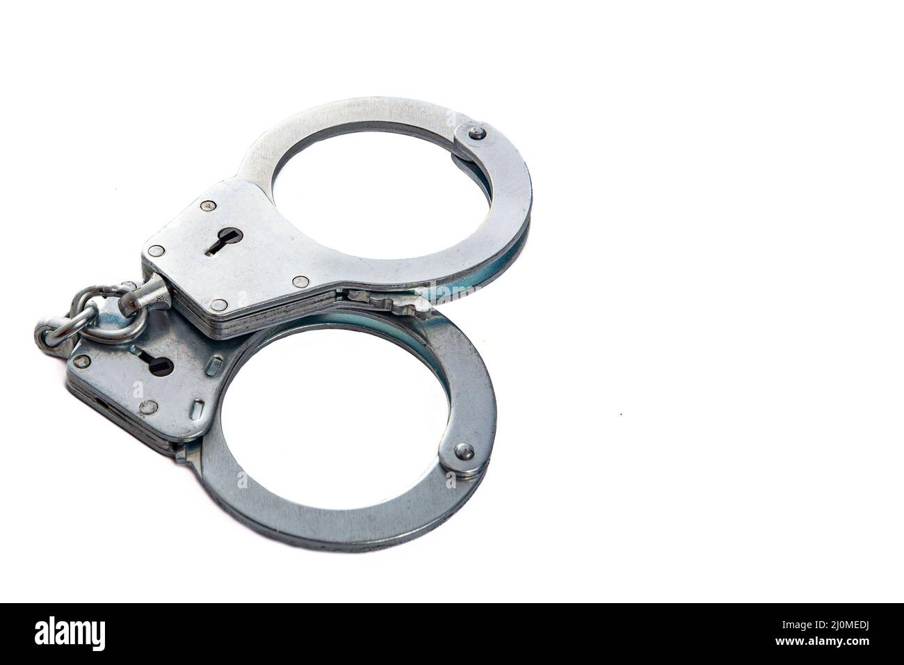 Metal handcuffs on a white isolated background, copy space Stock Photo