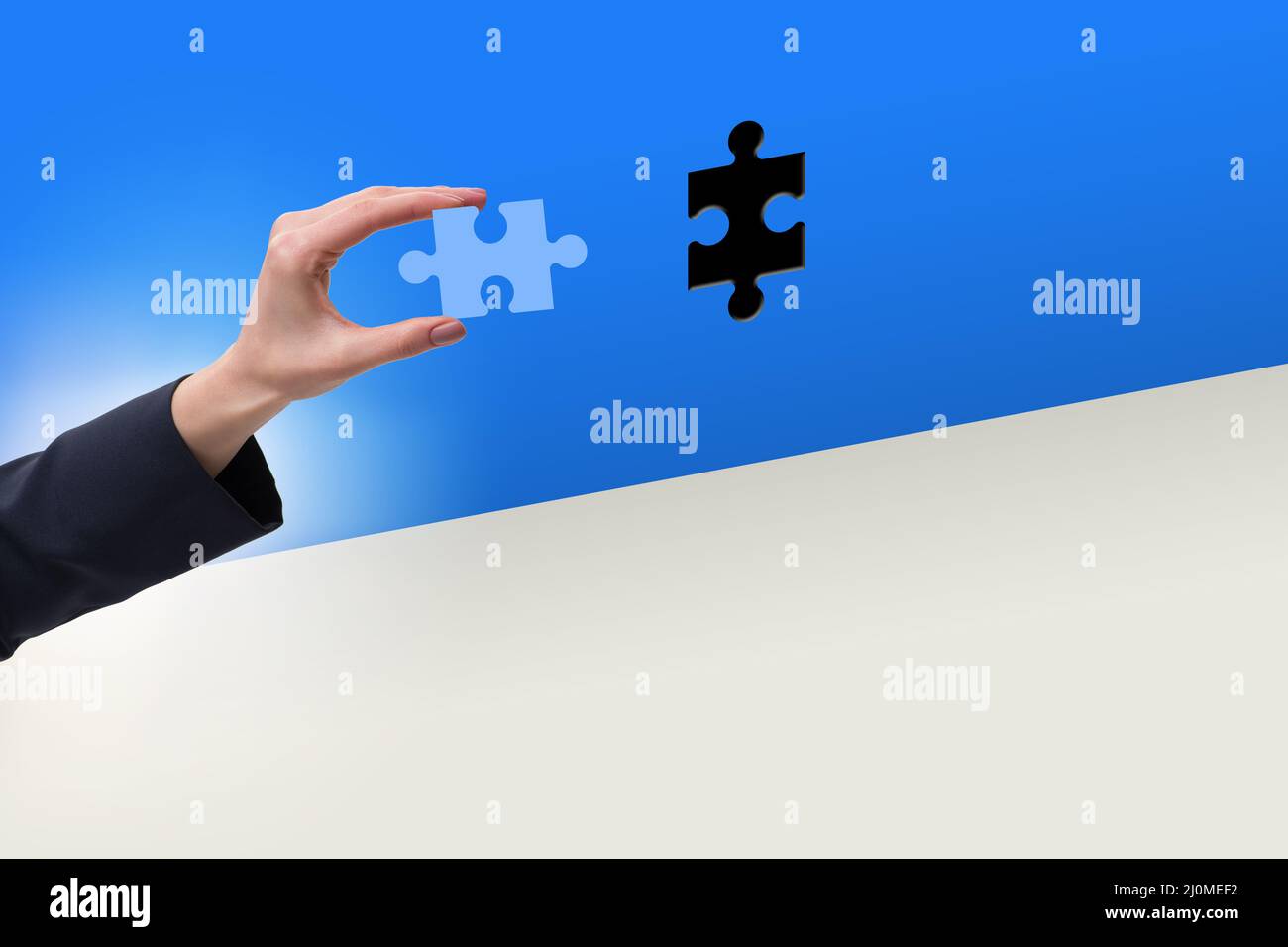 Businessman putting missing jigsaw puzzle piece Stock Photo Alamy