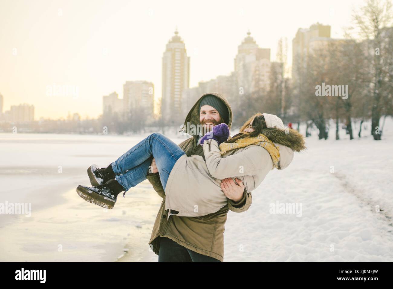Theme outdoor activities in winter. Loving couple man and woman Caucasian joy happiness happiness love emotions on the shore of Stock Photo