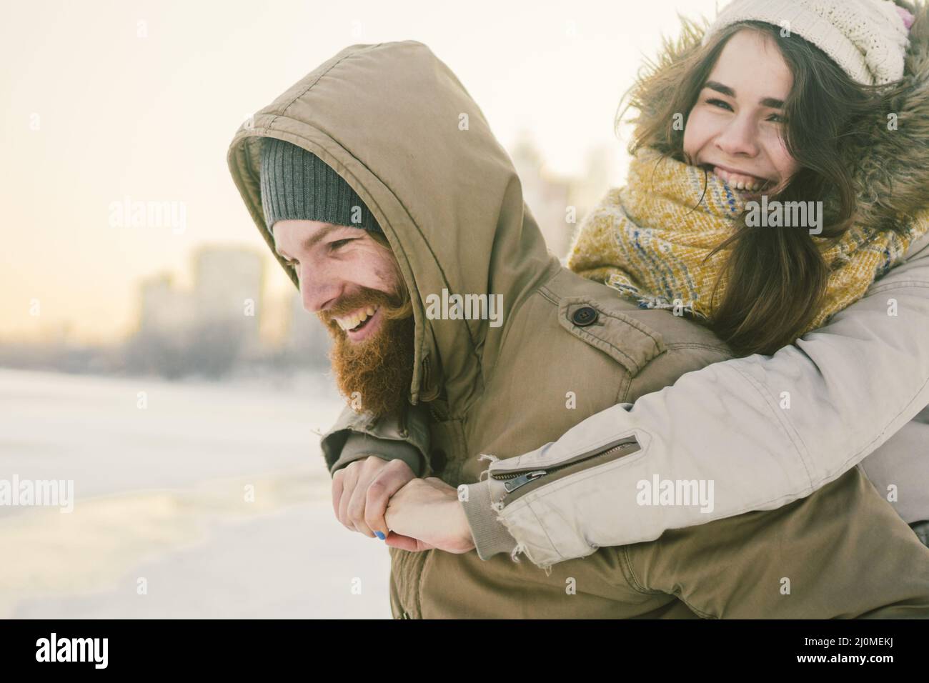 Theme New Year Christmas Mood Winter Snow Holidays Valentine Day. Young Caucasian couple lovers joy, laughter fooling water in c Stock Photo