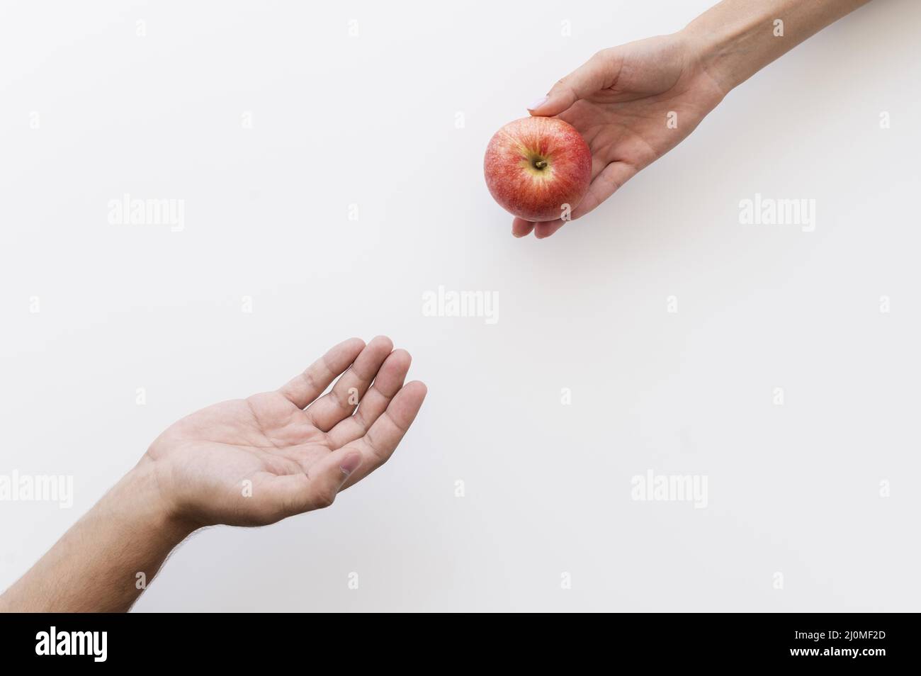 Hand giving apple needy person Stock Photo