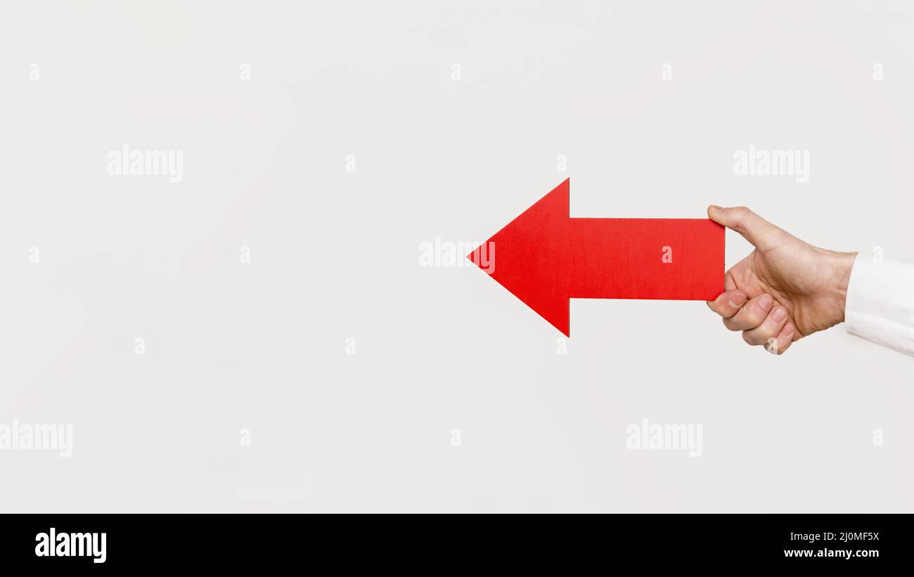 Hand holding red arrow Stock Photo - Alamy