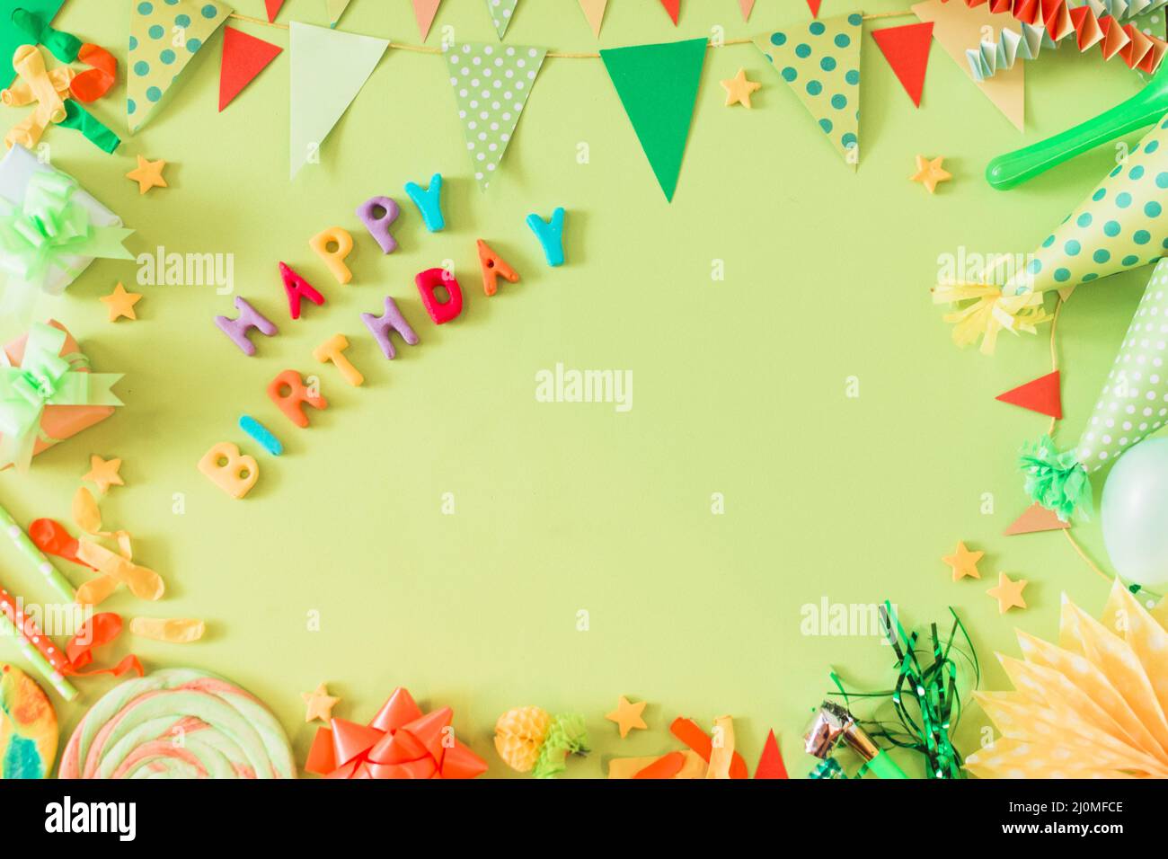 Happy birthday text with accessories green background Stock Photo - Alamy
