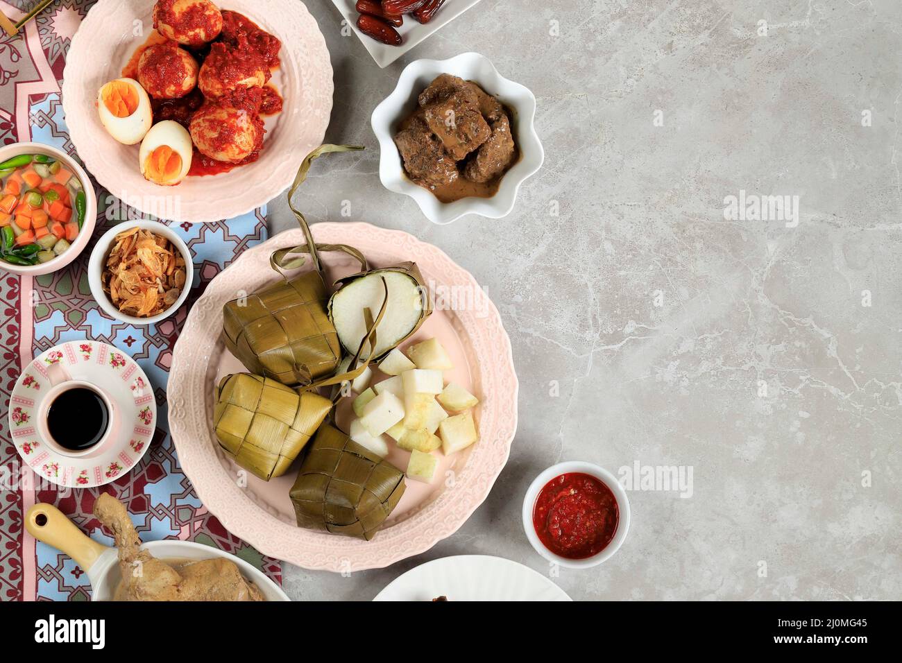 Ketupat Lebaran. Traditional Celebratory Dish of Rice Cake or Ketupat with Various Side Dishes, Popular Served During Eid Celebrations. Copy Space for Stock Photo