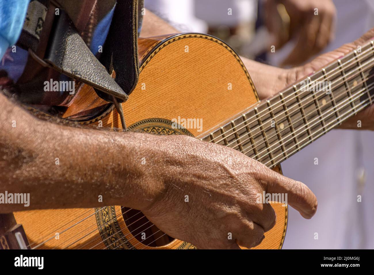 Detail of guitarist's hands and his acoustic guitar Stock Photo