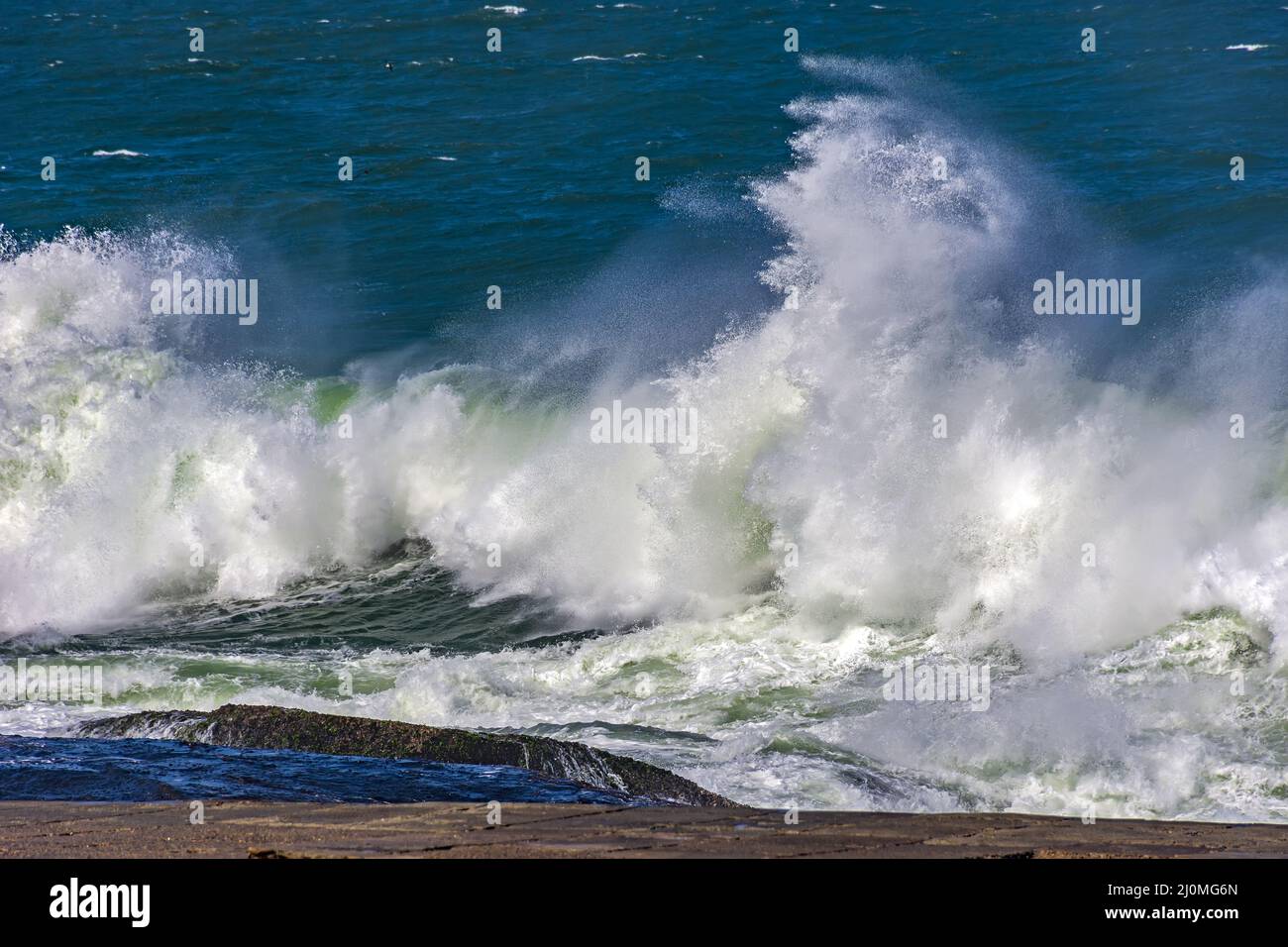 Strong waves crashing against rocks Stock Photo