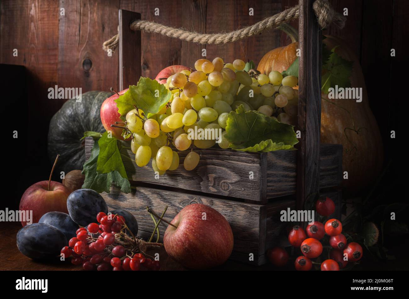 Grapes and other fruits on a dark wooden background in a rustic style Stock Photo