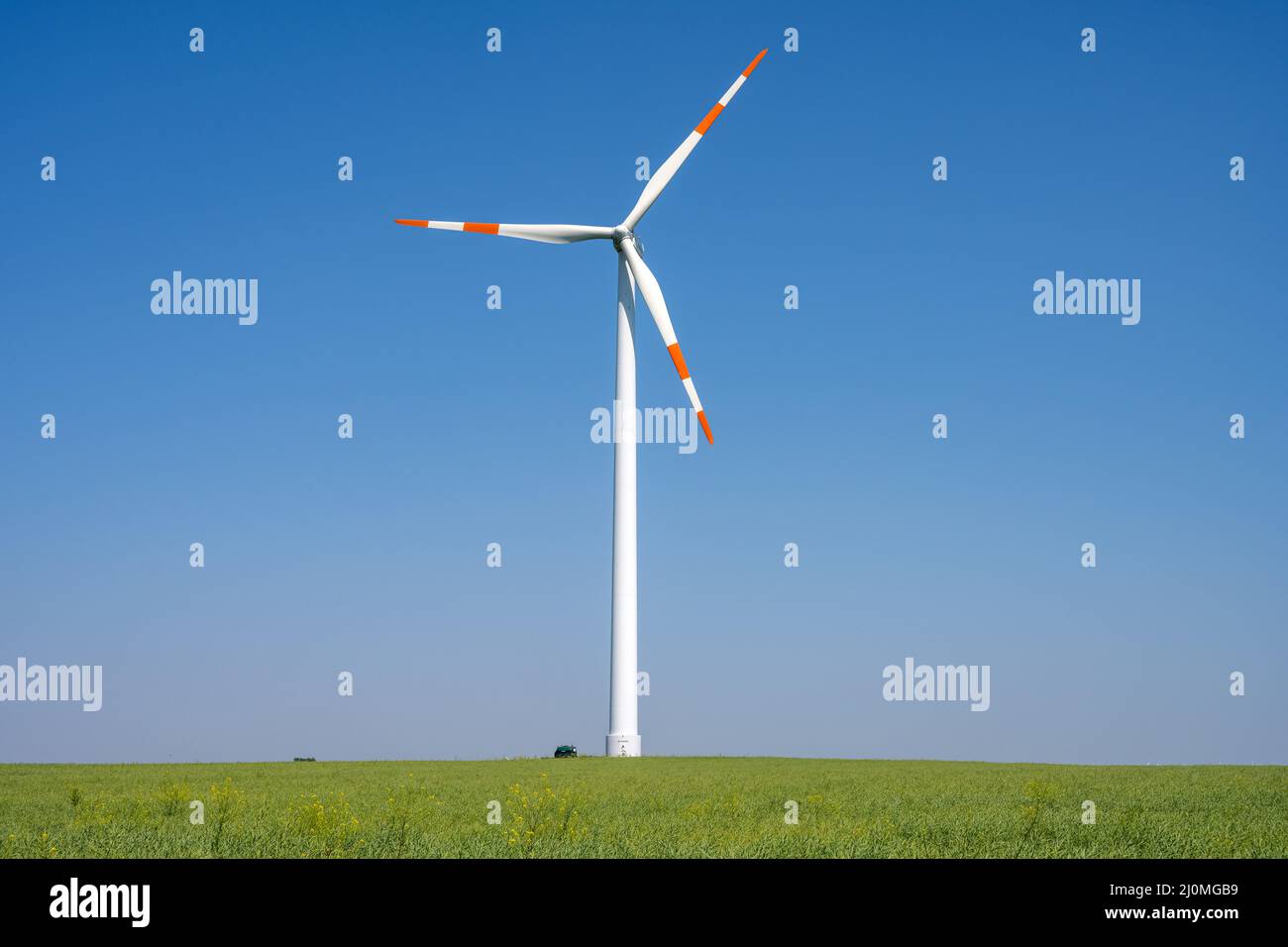 Modern wind turbine in front of a blue sky in Germany Stock Photo