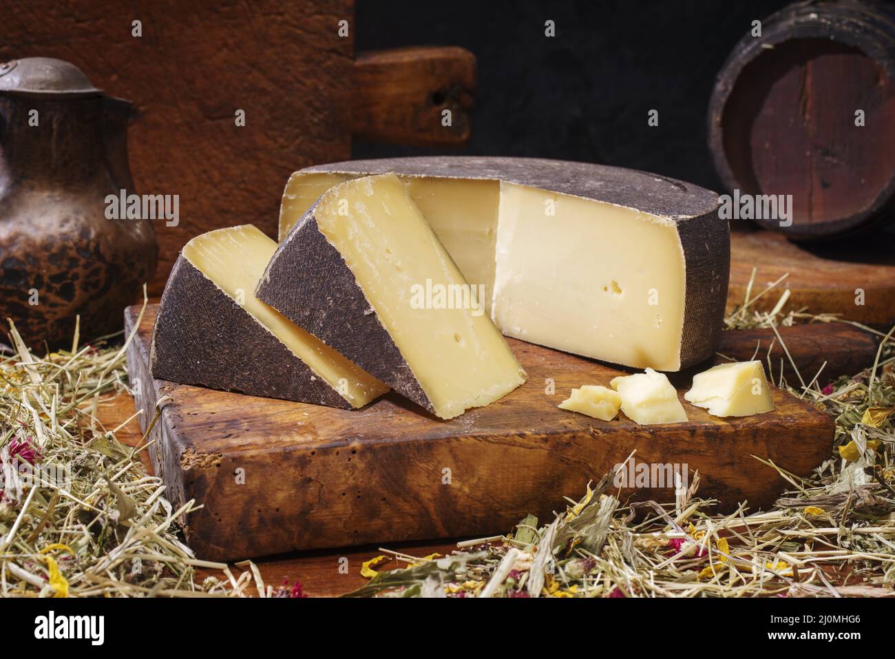 Traditional aged mountain cheese of the Alps offered as loaf and piece