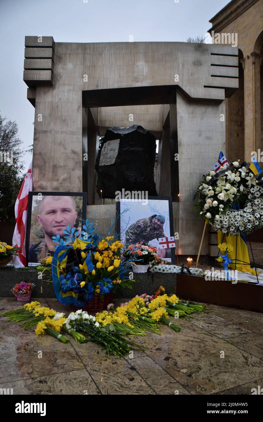 Tbilisi, Georgia. 19th Mar, 2022. A tribute with the photos of two Georgian volunteers Gia Beriashvili and David Ratiani killed in the Ukraine-Russia war on March 18th. Special units were created for some of the larger groups of foreigner fighters, including a Georgian and a Chechen battalion since 2014 in Ukraine. Russia invaded Ukraine on 24 February 2022, triggering the largest military attack in Europe since World War II. Credit: SOPA Images Limited/Alamy Live News Stock Photo