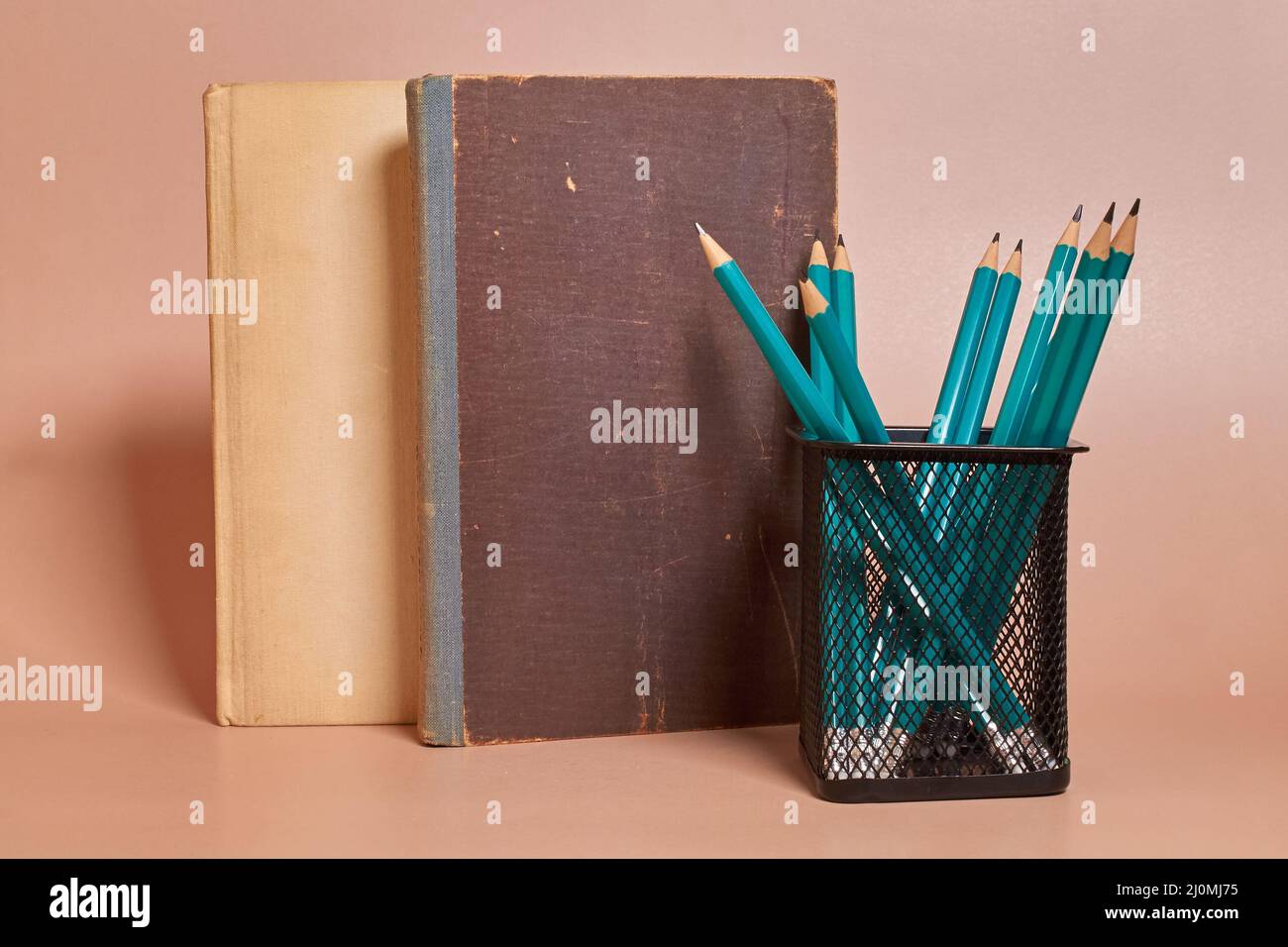 Next to the old books there is a glass with graphite pencils Stock ...