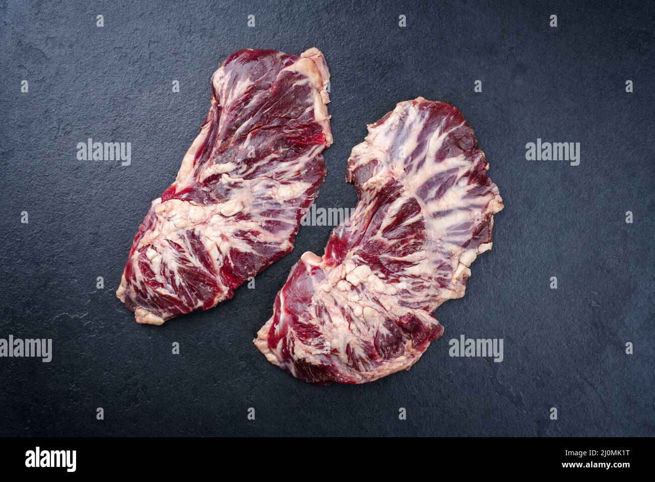 Raw wagyu spider beef steak offered as top view on a black board with copy space Stock Photo