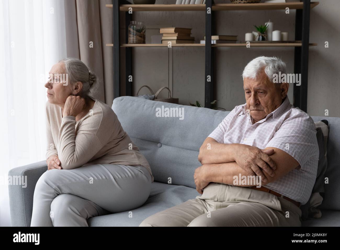 Middle aged couple sofa sitting apart hi-res stock photography and ...