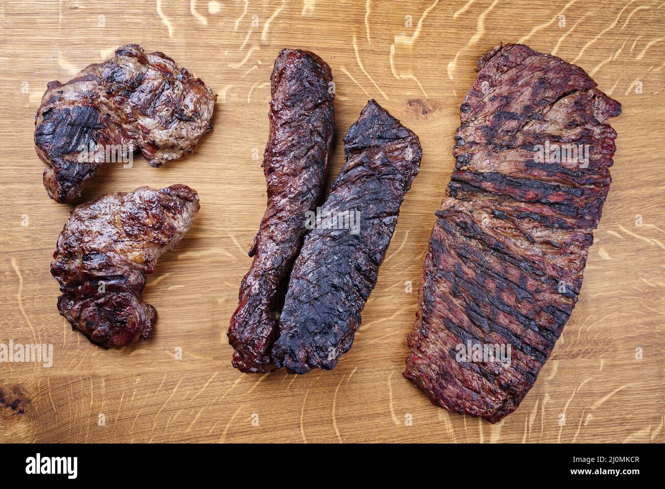 Traditional barbecue wagyu gourmet steaks served as top view on a wooden design board Stock Photo