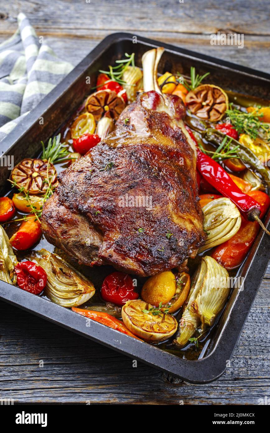 Traditional barbecue lamb shoulder with vegetables and chili served as