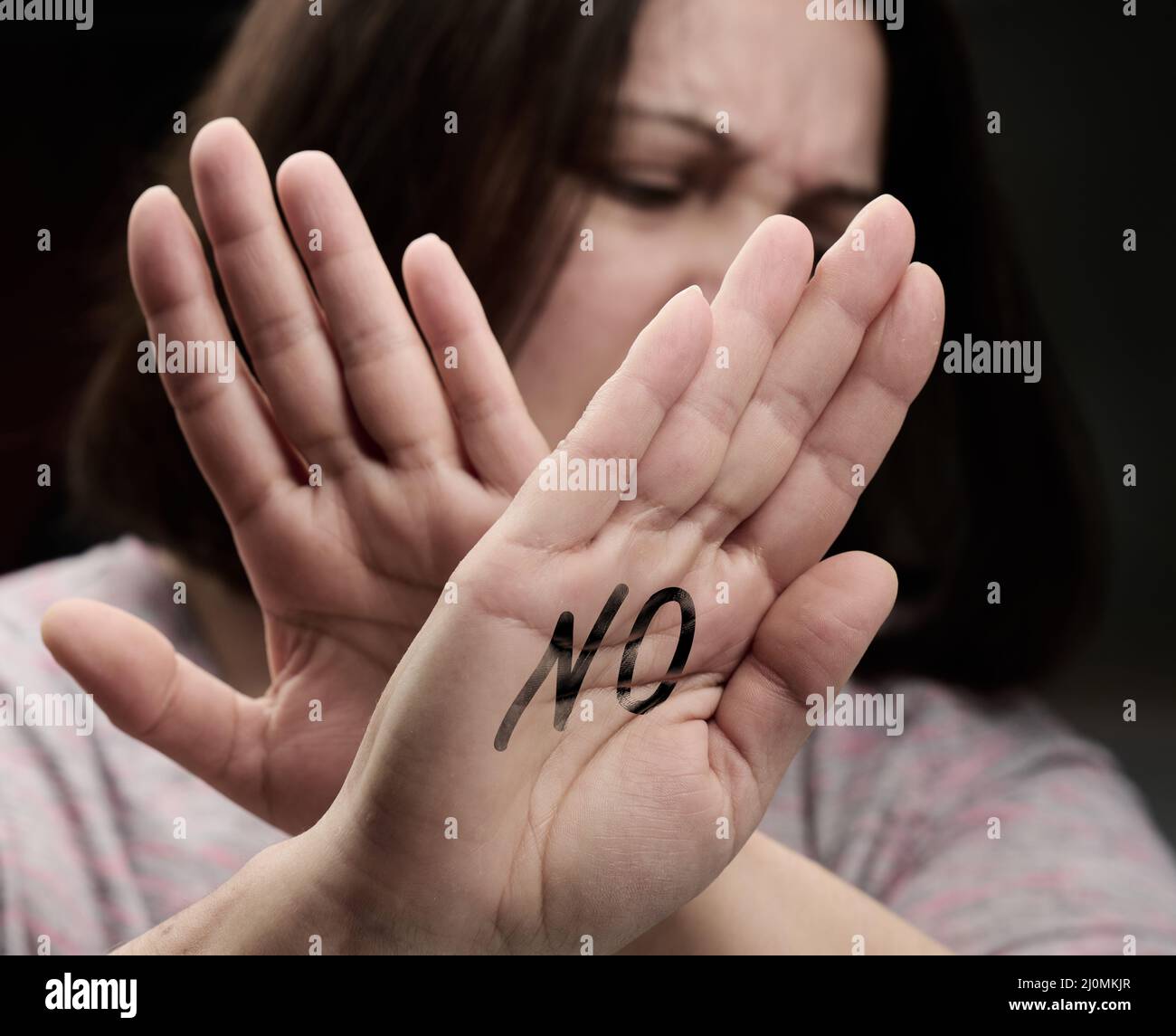 Woman stretched her palm forward, gesture of rejection of the offer, protection from violence. Stop Stock Photo