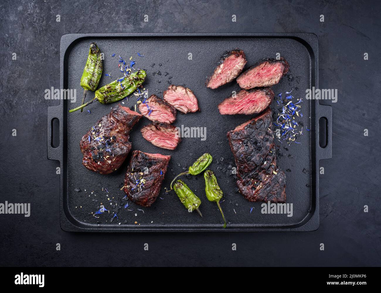 Modern style traditional barbecue wagyu onglet steak with green chili and spices served as top view on a design cast-iron tray Stock Photo