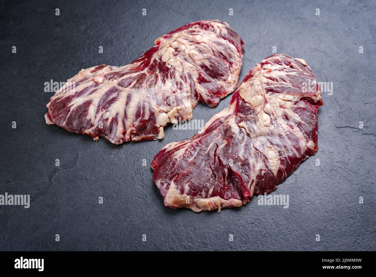 Raw wagyu spider beef steak offered as close-up on a black board with copy space Stock Photo