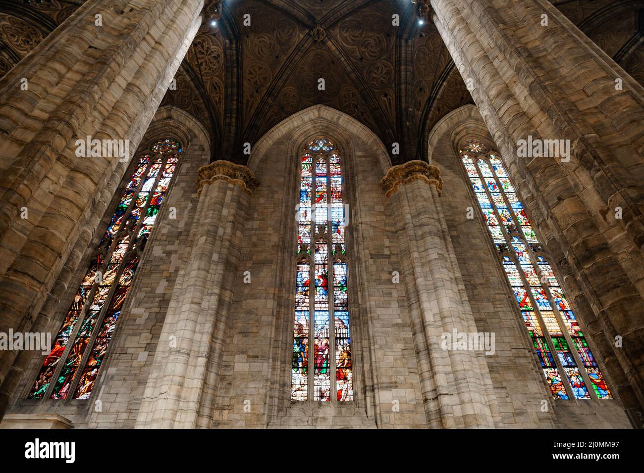 Multi-colored stained glass windows on the walls of the Duomo. Italy, Milan Stock Photo